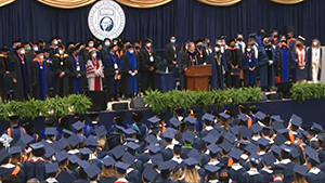 graduation, professors on stage and students in the audience